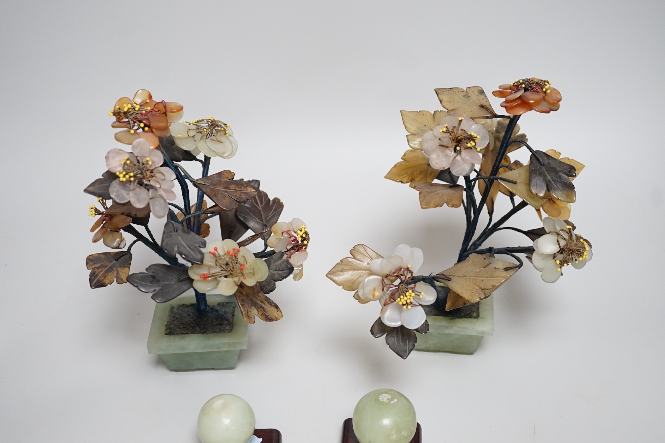 A pair of Chinese hardstone model trees and two model fruits, trees 21cms high